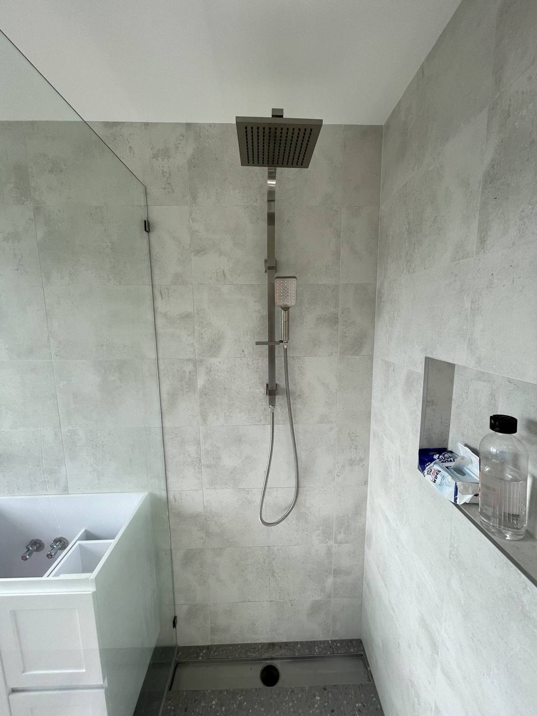 Finished walk-in shower after renovation with rainfall and handheld shower, recessed niche and terrazzo base, Baulkham Hills by Loel Homes