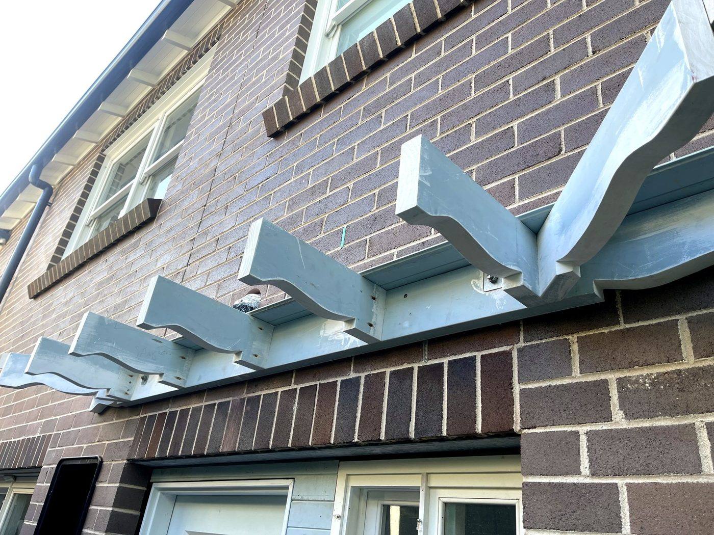 Full run of shaped decorative timber corbels and top rails fixed across a brick facade on an Eastwood home by Loel Homes