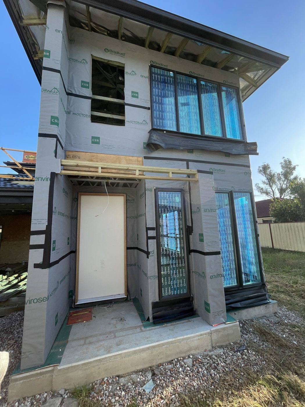 Finished rendered two-storey facade with clean fascia and trim by Loel Homes
