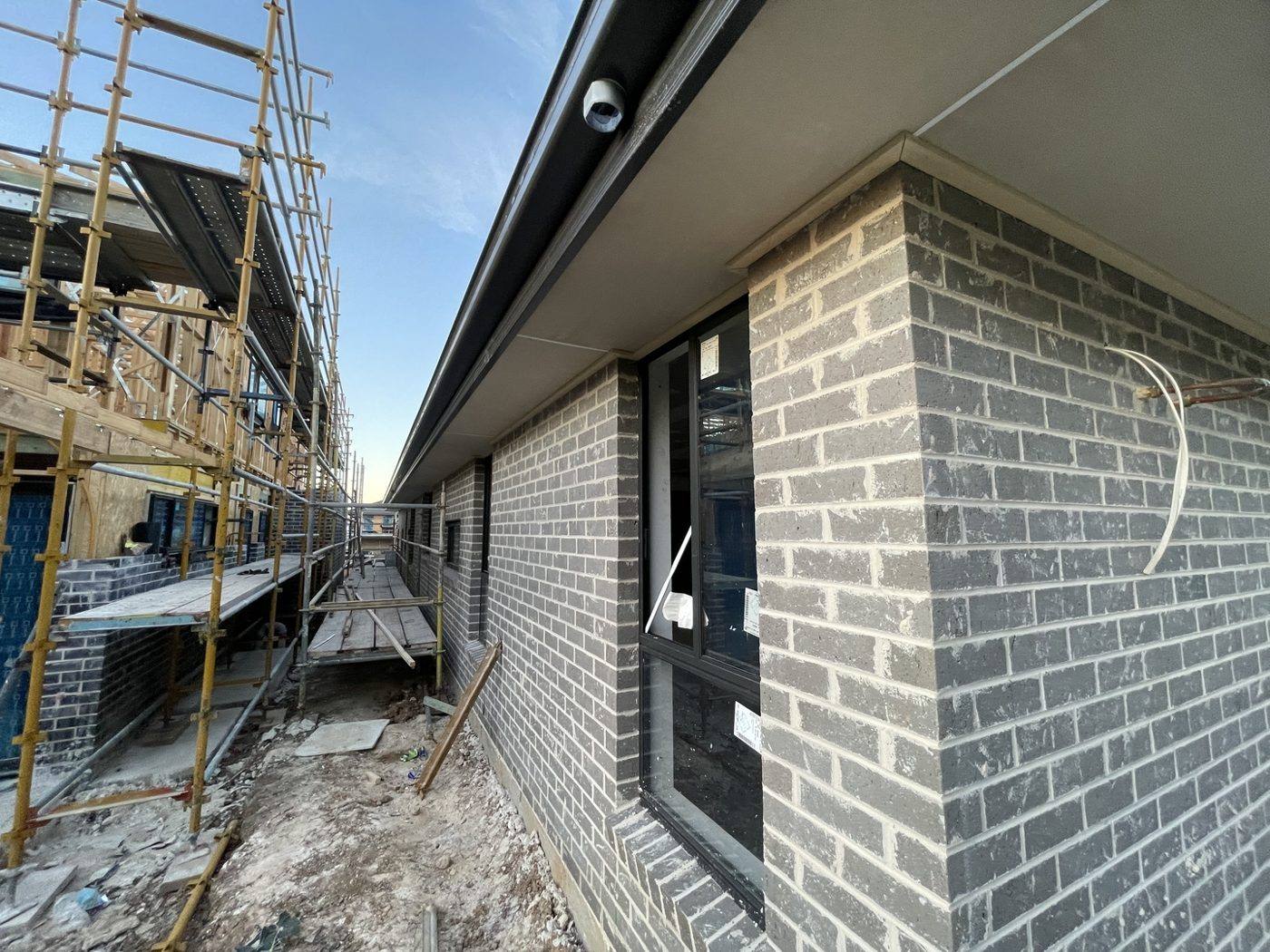 Brickwork with installed windows and dark fascia on a two-storey new build by Loel Homes