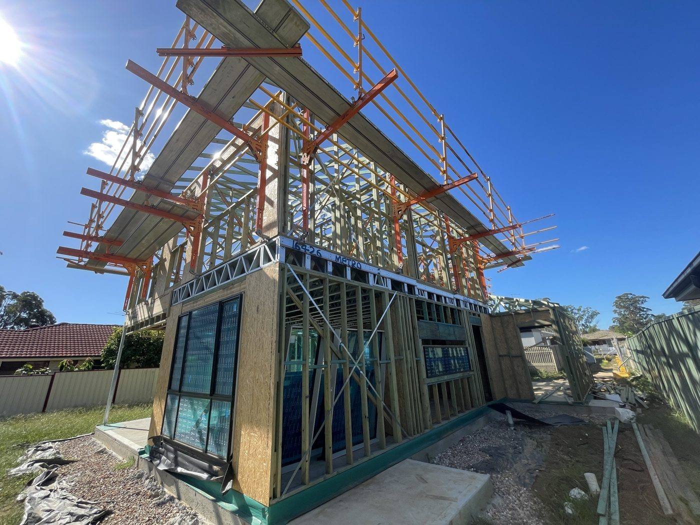 Steel and timber wall framing with roof trusses going up on a two-storey new build by Loel Homes