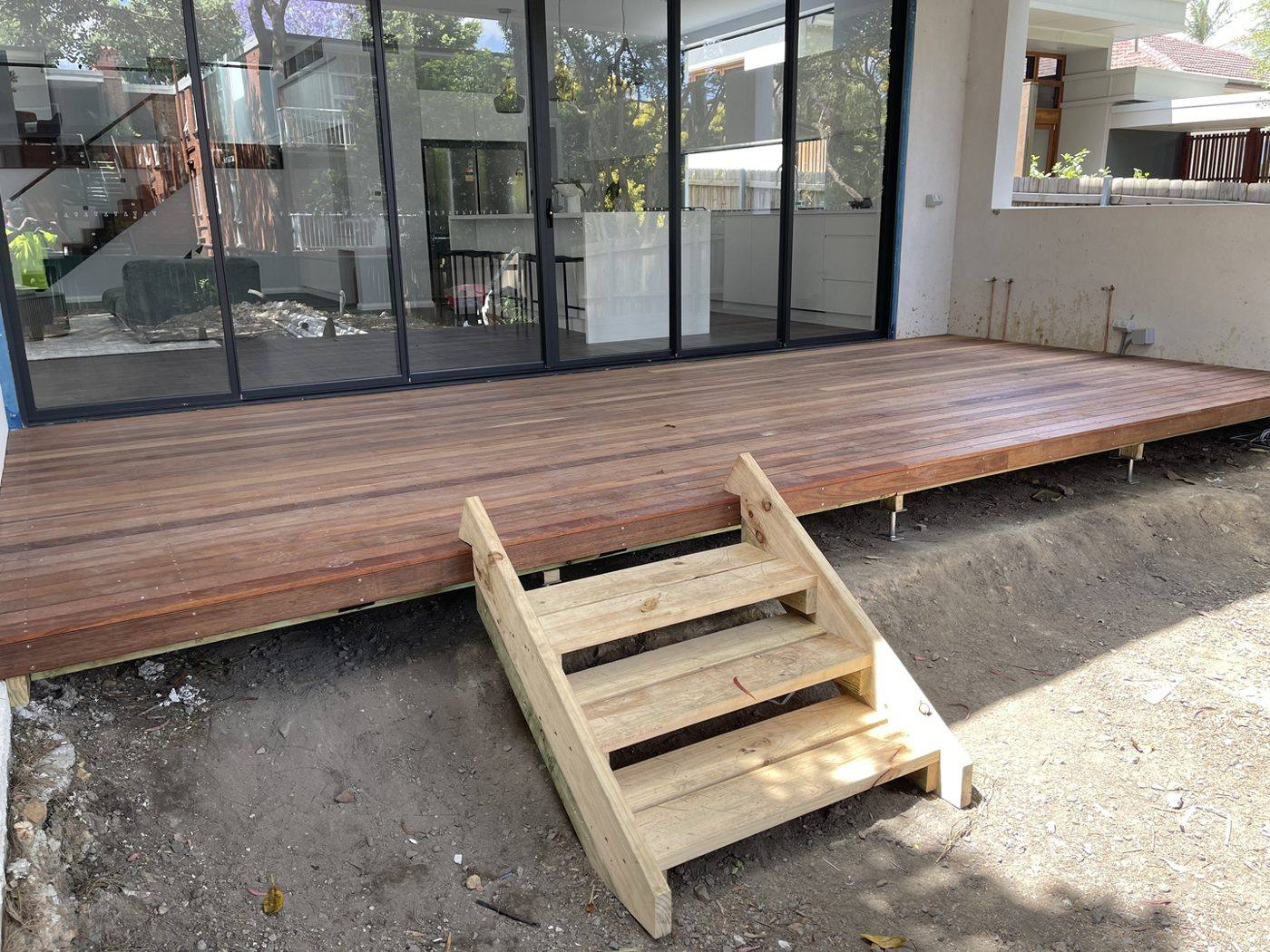 Finished hardwood deck with a new timber step down to the yard at the rear of the home by Loel Homes