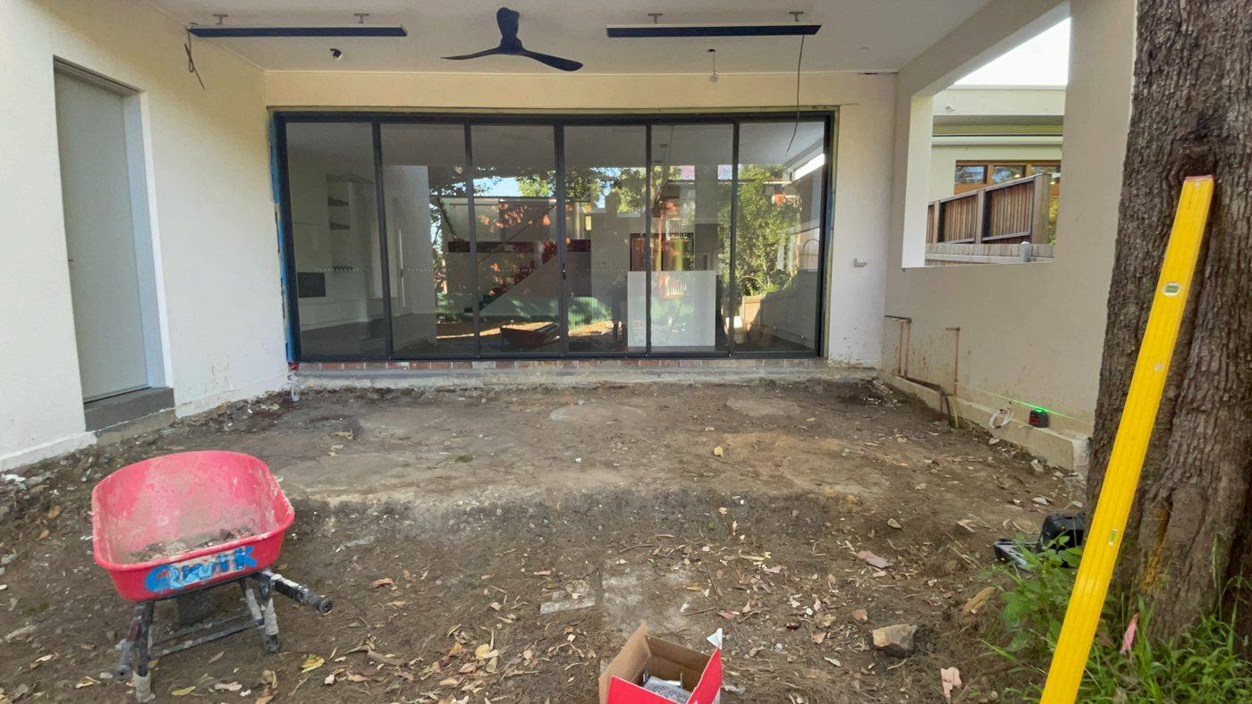 Bare dirt area at the rear of a rendered home before the hardwood deck was built by Loel Homes