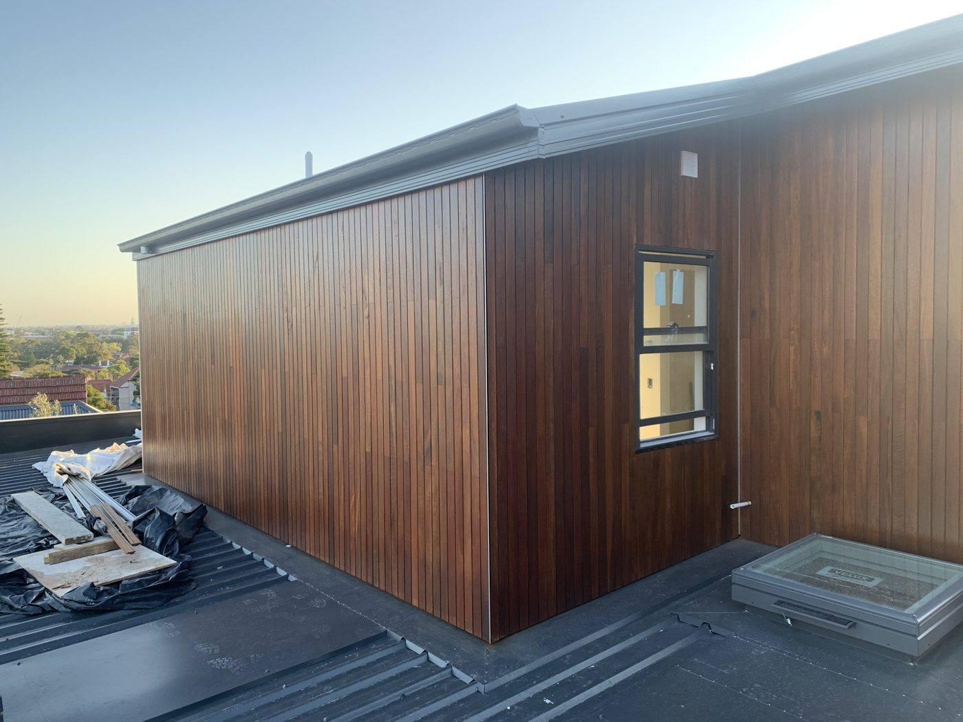 Side elevation clad in warm vertical timber under a skillion roofline, luxury home by Loel Homes